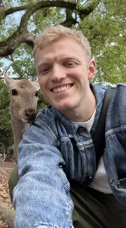 Luke Strugnell O'Donnell smiling beside a deer