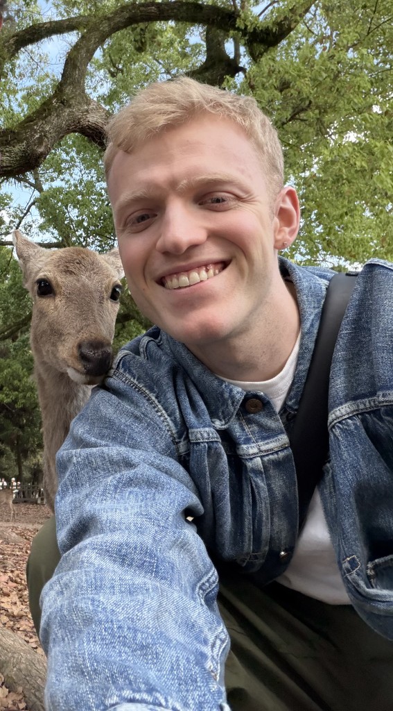 Luke Strugnell O'Donnell smiling beside a deer